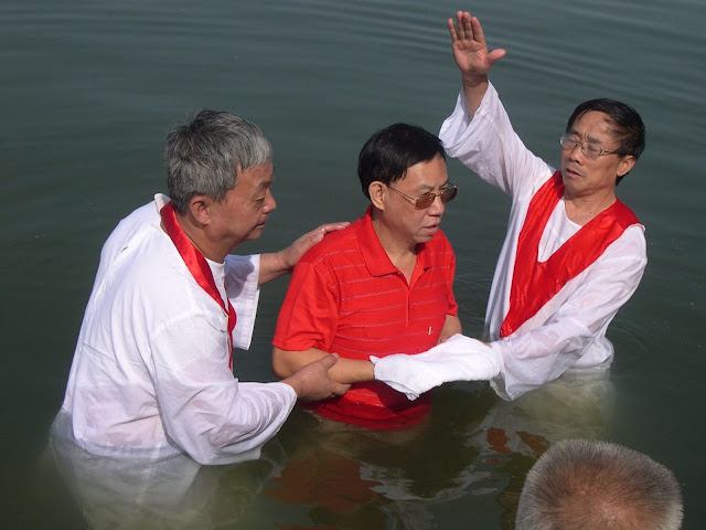 An image of Hu Shigen at a baptism. Hu Shigen is a pro-democracy activist and renowned church elder, currently waits out a seven-and-a-half year sentence on falsified charges of “subversion of state power."