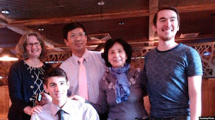 Pastor John Cao with his mother, wife, and two sons