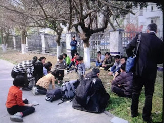 Members of persecuted Early Rain Covenant Church wait outside Yongquan Police Station for fellow believers