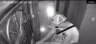 Surveillance footage showing a man obstructing a door lock