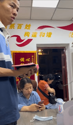 Chinese pastor Dai Zhichao leads a bible study in a police station
