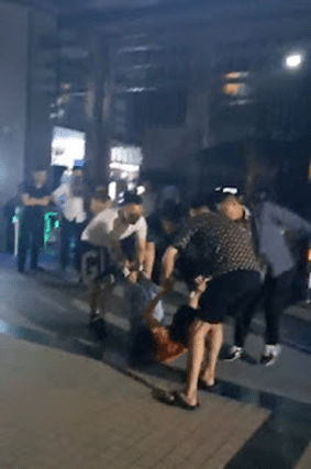 Security guards lift up Chinese Christian woman and throw her to the ground