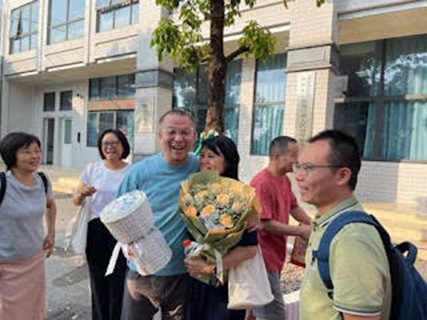 Elder Zhu Longfei embraces his wife outside the detention center