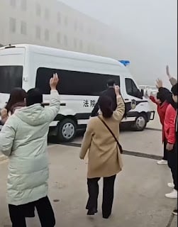 Christians from the Bengbu Living Stone Reformed church waiting for police vehicles to pass