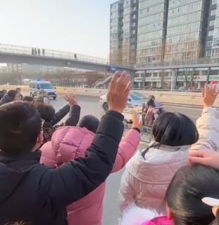 Church members waving at the prison van as it passed